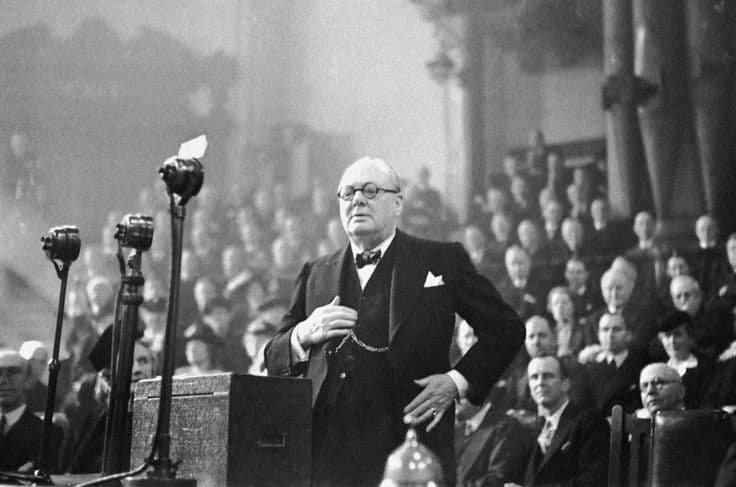 Winston Churchill speaking before microphones